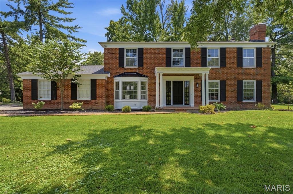 Welcome to 51 Brook Mill Lane, where timeless architecture, thoughtful design, and exceptional updates come together on a picturesque, nearly one-acre lot in the heart of Town & Country. This stately brick two-story home offers the perfect balance of refined elegance and everyday comfort, creating a place where life's biggest moments and simplest pleasures feel equally at home. From the moment you arrive, the mature setting and classic curb appeal create an unforgettable first impression. Step inside to discover beautiful hardwood floors, fresh paint throughout, updated lighting, and carefully curated finishes that make every room feel bright, inviting, and effortlessly sophisticated. At the heart of the home is the completely renovated kitchen, designed to be both beautiful and functional. Whether you're preparing weeknight dinners, gathering around the island with family, or entertaining guests, this space naturally becomes the center of everyday life. The adjoining family room offers warmth and comfort with custom built-in shelving, a cozy gas fireplace, and a wet bar that makes hosting everything from holiday celebrations to casual get-togethers feel effortless. The front living room provides an additional place to relax and unwind, featuring rich hardwood flooring and a classic wood-burning fireplace that invites quiet mornings with coffee or peaceful evenings by the fire. A formal dining room offers the perfect backdrop for holiday dinners, celebrations, and memorable meals shared with family and friends, while the thoughtfully designed mudroom helps keep everyday life organized. Upstairs, the primary suite serves as a true retreat, complete with a spacious walk-in closet and a beautifully renovated en suite bathroom designed with modern comfort in mind. Four additional bedrooms, each featuring hardwood flooring, provide flexibility for family, guests, home offices, or hobbies, while the completely renovated hall bathroom and conveniently located second-floor laundry add both style and practicality to daily living. The finished lower level offers additional living space ready to adapt to your lifestyle—whether you envision a recreation room, media space, home gym, or playroom. One of the home's most special features awaits just beyond the back door. The expansive screened-in sunroom creates a seamless connection between indoor and outdoor living, offering the perfect place to enjoy quiet mornings, family dinners, or peaceful evenings while overlooking the private, nearly one-acre backyard. Surrounded by abundant green space, the setting feels like a private retreat while remaining close to everything Town & Country has to offer. With a roof just four years old, extensive renovations throughout, and every detail thoughtfully updated, this move-in ready home offers the rare opportunity to simply unpack, settle in, and begin making memories from day one.