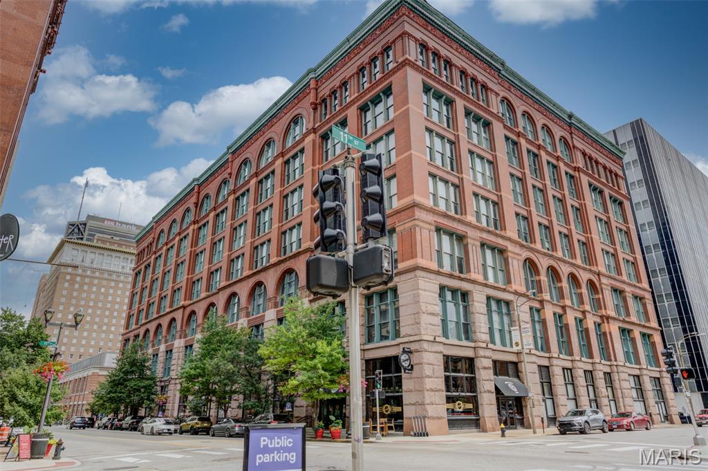 Experience the perfect blend of historic charm and modern luxury in this exceptional two-bedroom, two-bath loft located in the highly sought-after Washington Loft District. Showcasing soaring 16-foot restored timber ceilings, exposed brick walls, rich hardwood flooring, custom cabinetry, granite countertops, and stainless steel appliances, this home offers timeless character with contemporary finishes.

The expansive open-concept floor plan is bathed in natural light from oversized windows, creating an inviting space for both everyday living and entertaining. The spacious primary suite features a large walk-in closet and a private en-suite bath, while the second bedroom and full bath provide flexibility for guests, a home office, or a roommate. An additional walk-in closet and in-unit washer and dryer add to the home's convenience and functionality.

Enjoy resort-style amenities, including a rooftop deck with panoramic city views, a splash pool, and a barbecue grilling area—the perfect setting to relax or entertain friends and family. The building also features a modern smartphone-controlled security and access system, allowing you to conveniently manage building entry directly from your phone for added peace of mind.  A private storage unit provides valuable extra space, and two tandem parking spaces in the secure garage are included.

Ideally situated in the vibrant Washington Loft District, you'll be just steps from award-winning restaurants, entertainment, sporting venues, parks, and nightlife, with convenient access to major highways and everything downtown St. Louis has to offer.

Whether you're searching for your primary residence, a stylish downtown retreat, or an investment opportunity, this beautifully appointed loft offers an exceptional combination of location, character, and modern urban living.