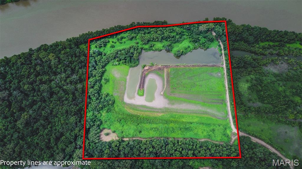 Calling all waterfowl hunters! This 25± acre recreational property commonly known as Tip Island offers an established hunting setup in one of Greene County's most desirable waterfowl areas. Situated in the heart of the renowned Illinois River Flyway, this tract sits across from the refuge and Diamond Island area and has a proven history of ducks, teal and geese. Located at the end of private dead end road with year round gravel access, the property offers privacy and seclusion serious hunters are looking for. Approximately 18 acres can be flooded for waterfowl hunting using a tractor and pump, with an established levee system running through the hunting area. A strategically placed duck blind allows hunters to hunt both sides of the flooded ground, providing flexibility based on wind and bird movement. 23.75 Acres in a CREP Easement.  One Acre which includes the boat ramp and club house area is NOT in the CREP program.  The property also features an existing boat ramp, providing access to the surrounding waterways for fishing and boating. When duck season is over, the recreational opportunities don't stop—whitetail deer and turkey are abundant throughout the area, making this a true multi-season hunting and recreational property. Want to make this a truly turnkey waterfowl property? Ask about additional equipment and hunting items available for separate purchase, including a tractor, pump, hoses, brush hog, blade, fuel tank, duck blind, decoys and more. A buyer could have the opportunity to purchase not only an established duck hole, but much of what is needed to hunt and manage it from day one. With its private ownership, highly sought-after location, established waterfowl habitat, proven hunting history, controlled flooding capability, private access, boat ramp, and additional deer, turkey, fishing and boating opportunities, this is much more than 25 acres of recreational ground. It's an opportunity to own your own private piece of a premier Illinois River hunting corridor—the kind of property that doesn't come available often.