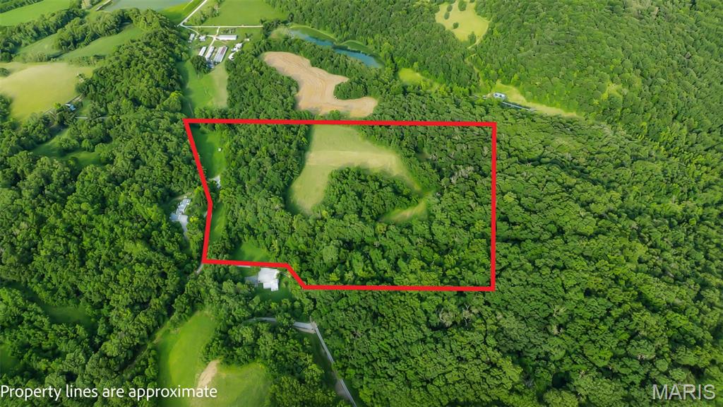 Escape to your own private retreat on this exceptional 40± acre recreational farm just south of Hardin in beautiful Calhoun County. Tucked away on a dead-end road, this property offers the peace and privacy outdoor enthusiasts are looking for. Known for its outstanding whitetail deer and duck hunting, the farm features approximately 7 acres enrolled in CRP, plus an additional 2 acres established for food plots to help attract and hold wildlife. An established trail system winds throughout the property, providing easy access for hunting, hiking, ATV riding, or simply enjoying nature. A pond adds to the recreational appeal and provides a landing spot for ducks. The impressive 30' x 50' pole building has a new roof and is insulated with HVAC, making it comfortable year-round. Inside you'll find a full bathroom with a tankless hot water heater and washer/dryer hookups, offering all the conveniences needed for weekend getaways or hunting camp. The property is currently set up with three full-hookup camper sites, making it ideal for hosting family and friends or enjoying immediately while planning your future home. With utilities already in place and a beautiful setting, this property also offers an outstanding building site for your dream home or cabin. Whether you're looking for a premier hunting property, a recreational getaway, or the perfect place to build, this Calhoun County farm is ready to enjoy from day one.