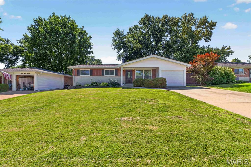 Welcome home to this beautiful 3-bedroom, 2-bath ranch in the quiet Glen Arbor Estates! This brick home features an open-concept layout with a stunning marble-top island, durable faux wood tile flooring, crisp white cabinetry, a stainless steel sink with a gooseneck faucet, and a cozy brick fireplace. The finished lower level offers even more living space, complete with a marble-top wet bar—perfect for entertaining, and a bonus sleeping area or office. Step outside to a fenced backyard ideal for relaxing, pets, or play. Conveniently located near parks, restaurants, shopping, and with quick access to I-55 and I-270, this home offers both comfort and convenience!