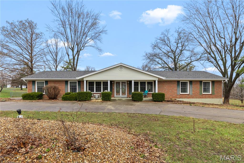 **Motivated Sellers**Expansive ranch on 1.79 acres backing to peaceful woods, with access to a beautiful 7-acre community lake. The evening setting highlights the home’s warmth, natural light, and serene surroundings.

Step inside to find gleaming hardwood floors and an open floor plan featuring a spacious great room with gas fireplace and an elegant dining area. The luxury kitchen offers custom cabinetry, quartz countertops, stainless steel appliances, a gourmet gas range with hood and pot filler, tile backsplash, breakfast bar, and coffee bar.

The massive primary suite includes bay window, multiple closets including a walk-in, and a spa-like bath with travertine tile, dual vanities, soaking whirlpool tub, and separate shower.

The finished lower level provides excellent flexibility with a full in-law suite featuring a kitchen, dining area, gas fireplace, sunroom, bedroom, full bath, and storage—ideal for multigenerational living or extended guests.

Additional features include a large composite deck, smart home power blinds, new architectural roof (Fall 2024), easy-care vinyl/brick exterior, and a covered porch. Located in the award-winning Wentzville School District and just 2 minutes from I-70 for convenience.