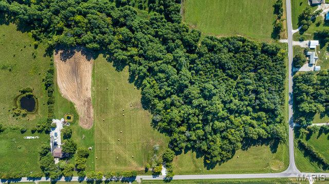 21 +/- acres in Unincorporated Eastern Warren County, MO. Conveniently located between Columbia and St. Louis, MO just minutes from Interstate 70 in one of the fastest growing counties in Missouri. Great development opportunity located near entertainment. Prime location with 1762+/- feet of state highway road frontage at intersection of State Highway M & State Highway OO. Electric on site, some open ground, some wooded, some trails. Would lay out nicely for building homesites. Well suited for 1031 Tax Free Exchange. Listing includes 3 Tax ID Numbers: Tax ID: 11020000008001000, 11020000008000000, 11020000007001000.  Minimal deed restrictions will apply. No HOA.
