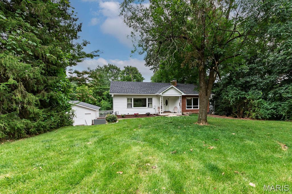 Stylishly charming and move-in ready, this adorable 2-bedroom, 2-bath split-bedroom ranch sits on a rare 1.3-acre lot in the heart of Imperial! From the mature landscaping and expansive front yard to the oversized 2-car detached garage—every hobbyist’s or mechanic’s dream workshop—this property offers space and possibilities that are hard to find in the area.
Inside, you’ll love the bright and inviting living room featuring recessed lighting, laminate flooring, and a large picture window that fills the home with natural sunlight. The designer-inspired dining room creates the perfect setting for gatherings, while the spacious U-shaped kitchen serves as the heart of the home with abundant storage, and an ideal flow to the living and dining areas for effortless entertaining.
The primary bedroom offers generous space with his-and-hers closets, while the charming guest bedroom includes custom closet organizers. A beautifully updated main-floor bath adds a fresh, modern touch that will brighten every morning.
The finished lower level expands your living space with a cozy wood-burning fireplace, recreation area, second full bath, laundry area, abundant storage, and plenty of room to add additional finished living space for future value. Step outside to enjoy both a patio and separate screened-in porch overlooking the massive backyard—a truly rare setting for Imperial.
To top it off, the sellers are offering a home protection plan and have already obtained a passed Rock Creek sewer lateral certificate for added peace of mind. Homes with this much character, land, and functionality don’t come along often—schedule your showing today before it’s gone!