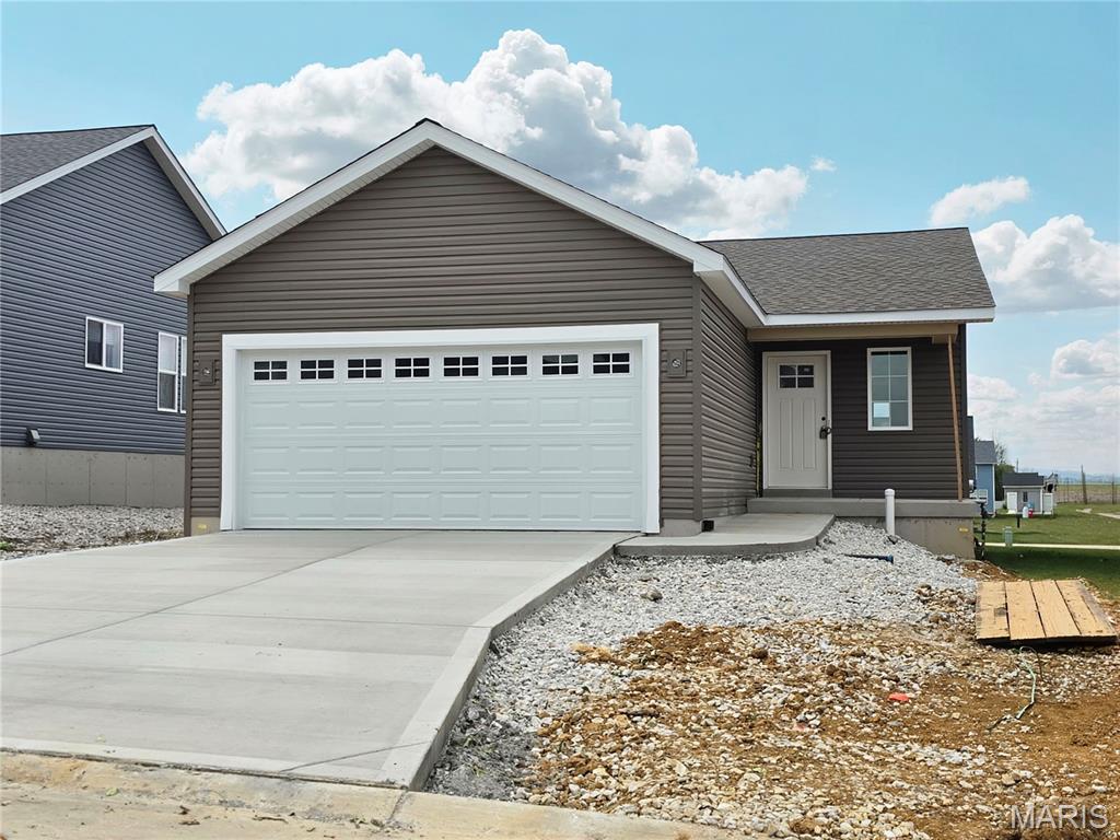 Welcome to the lovely and efficient Tulip ranch by Houston Homes located in the picturesque Majestic Lakes community of Moscow Mills. This smartly designed 1,200 sqft ranch features 2 bedrooms and upgraded 2 full bathroom layout. Curbside the home displays a timeless neutral palette enhanced by a windowed garage door on the 2-car garage, alongside full seamless gutters and fascia. Step inside and you will find durable laminate flooring that flows directly into the bright great room and kitchen. The well-appointed kitchen serves as the center of the home, featuring 42” premium soft-close cabinetry, sleek granite countertops, an ice-maker water line, and a Moen matte black pull-down faucet. An upgraded center kitchen island offers relaxed seating for guests, while the full GE stainless steel appliance package -complete with a dishwasher, microwave and electric range – makes every day cooking a breeze. Enjoy the convenience of a dedicated main-floor space designed for a stackable washer and dryer. The home offers a private ensuite owner’s bath and separate guest bath. The owner’s bath includes a spacious 5-foot shower with built-in seat. Downstairs, the full 8’ walk-out basement comes pre-plumbed with a ¾ bath rough-in, providing the ideal canvas to expand your living space as your needs grow. Located in the serene setting of Majestic Lakes just minutes from Wentzville and a short drive down the road from Troy, this exceptional home offers quality comfort, and outstanding value.