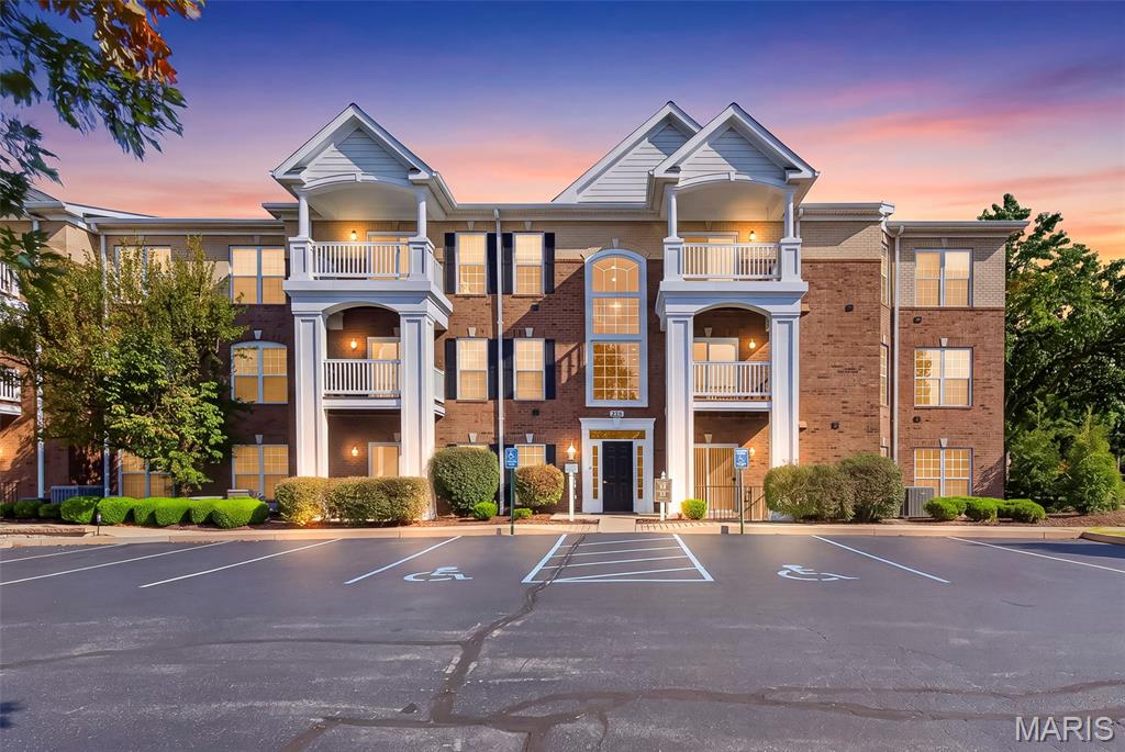 Welcome to Mill Crossing Condominiums! This beautifully maintained 2-bedroom, 2-bathroom second-floor condo offers comfortable, low-maintenance living in a park-like setting with abundant green space. The open floor plan features a spacious kitchen with granite countertops, breakfast bar, pantry, and updated stove, refrigerator, and garbage disposal. The kitchen opens seamlessly to the dining area and living room, creating an inviting space for entertaining. A gas fireplace adds warmth and ambiance to the living room. Wood flooring flows throughout the main living areas, while both bedrooms feature fresh, new carpet. The spacious primary suite offers a walk-in closet and private bath with extra long vanity, separate tub, and shower. The second bedroom is conveniently located near the full hall bathroom. Both bathrooms feature updated toilets. Laundry room with stackable washer and dryer that stays with the home. Enjoy the ease of second-floor living with elevator access. Additional amenities include an underground garage accessible by elevator with assigned parking space, plus ample surface parking for additional vehicles and guests. The HOA includes access to the community clubhouse, work out room and pool. Conveniently located in Parkway School District with easy access to highways 141, 270, 40/61, and 364, this condo offers an ideal combination of comfort, amenities, and convenience. Move-in ready and ready to welcome you home!