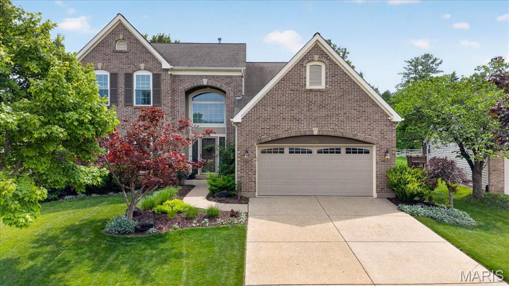 With its gorgeous neutral brick facade set against lush green lawns and manicured landscaping, this home delivers the kind of curb appeal that makes you slow down and take a second look. Inside, a welcoming two-story floor plan showcases a warm, designer-inspired palette and thoughtful updates throughout, creating spaces that feel both stylish and effortlessly comfortable.

The dramatic two-story entry welcomes you with rich hardwood floors and draws you into the heart of the home, where the great room, breakfast room, and kitchen flow seamlessly together. Flanked by built-in bookshelves, a cozy fireplace anchors the great room, which is equally suited for gathering with family and friends or curling up with a good book at the end of the day.

The beautifully updated kitchen blends charm and function with shaker-style cabinet fronts, a decorative brick backsplash, Thinscape countertops, reverse osmosis water system, floating shelves, and upgraded appliances. It's easy to imagine leisurely weekend mornings making pancakes while conversations drift effortlessly between the kitchen and adjoining living spaces. At the center of it all, the breakfast room keeps everyone connected—whether you're helping with homework at the table, chatting with guests gathered in the great room, or enjoying a leisurely weekend breakfast before heading out to the patio and beautifully landscaped backyard. Outside, there's plenty of room for entertaining, relaxing, or letting kids and pets run and play.

The separate dining room, enhanced by custom board-and-batten wall treatments, provides a beautiful backdrop for everything from intimate dinner parties to large holiday celebrations.

The laundry room is as pretty as it is functional, featuring updated flooring, additional cabinetry for storage, and thoughtful finishes that make everyday tasks feel a little more enjoyable.

Upstairs, the spacious primary suite offers both a walk-in closet and an additional traditional closet, along with a refreshed ensuite bath featuring an updated dual vanity, new sinks and fixtures, separate tub and shower, and a filtered water showerhead. Three additional bedrooms and a full hall bath complete the second floor.

The lower level offers a blank canvas for future finishing and is already being creatively enjoyed as a workout and recreation space.

Additional updates include a new HVAC system and dishwasher in 2025.

Lovingly maintained and thoughtfully styled, this home showcases designer paint colors, custom-crafted wall treatments, updated lighting, and a welcoming atmosphere throughout. Located within the Rockwood School District and feeding to Lafayette High School, 1559 Englebrook Drive is the perfect blend of comfort, character, and modern living.