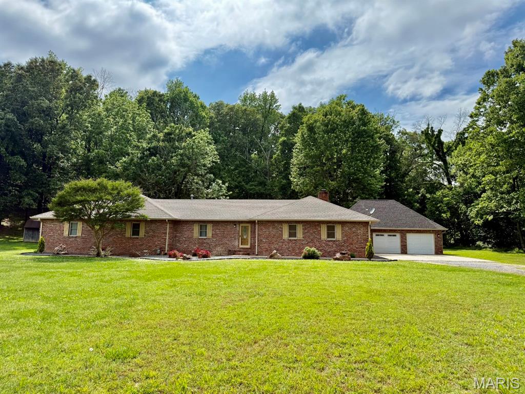 Nestled on 4 picturesque acres, this charming brick home features 3 spacious bedrooms and 4 bathrooms, 2 of the oversized bedrooms include private en-suite bathrooms, creating ideal retreat spaces. 3 of the 4 bathrooms have been beautifully updated w/ tile finishes, adding a modern touch throughout the home. The kitchen comes fully equipped with all appliances included, making this home truly move-in ready. You’ll also appreciate the expansive laundry room, complete with abundant cabinetry for exceptional storage and organization.  There is a vaulted loft showcases unique woodwork, adding warmth and character to the home’s design. A partial basement provides even more storage space to meet your needs.  There is also a whole home generator in case of a power outage.  The property also includes a versatile 25’ x 25’ outbuilding with a concrete floor, electricity, and water already in place—ideal for a workshop, storage, hobbies, or livestock.