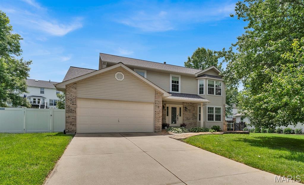 Are you looking for a wonderful 2-story home in a fabulous location in O’Fallon?  This great home is hitting the market only because of an “out -of-town” move, giving the next buyers the opportunity to live in and love this home like the sellers have.  Step onto the spacious covered porch and prepare yourself for great surprises!  Past the craftsman-style front door and sidelights, you’ll find a great main floor that is light and bright, with bay windows, atrium doors, and loads of windows.  All carpet on the main and upper level has just been replaced.  With a spacious living room, and a large family room with a brick, wood-burning fireplace, in addition to a separate dining room, and large kitchen with a breakfast room, there is space galore!  Upstairs find a spacious primary bedroom with bay window, a large walk-in closet, and a primary bathroom with soaking tub and separate shower.  Three additional bedrooms complete the main, with a nice hall bathroom with custom tile shower and ceramic tile flooring.  All windows on the main and upper level have either plantation shutters or custom Hunter Douglas shades.  The seller had a new roof installed in 2022, as well as a new vinyl privacy fence. Large deck off the kitchen and a patio extend the entertaining space out into the beautiful backyard.  Great House + Beautiful Yard+ Community Pool & Clubhouse + Francis Howell Schools + fabulous highway access nearby at K and Hwy 40, plus all the shopping and restaurants that Hwy K and surroundings have to offer= YOU DON’T WANT TO MISS THIS ONE!