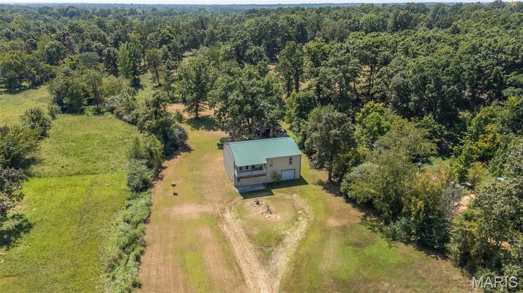 Come take a look at this  unique 3 bedroom, 3 bathroom home situated on 7+/- acres just outside of town, offering the perfect combination of convenience, space, and privacy. 

This home features a spacious living area upstairs alongside generously sized bedrooms! While the main floor offers endless potential. Currently set up to be a recording studio now but could be turned into whatever you could imagine. Some added highlights to this place is it has an elevator providing easy access to the upstairs, and an attached garage. Located up the hill on this property is a fixer upper house that could potentially bring in an extra income. 

With 7 acres to enjoy, there’s plenty of room for outdoor activities, animals, entertaining, or simply enjoying the peace and privacy of your own property. It is truly a unique property with so much to offer and a location that’s hard to beat!