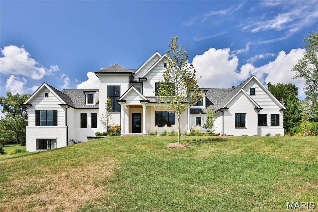 A light-filled, gorgeous 3-year-old one and a half-story home. Interior features include white oak flooring, custom cabinetry, white oak beams, a 10 foot kitchen island, a hidden pantry, barn doors, ship lap, 10-foot first-floor ceilings, 9 foot second-floor ceilings, and a stair tower with paneled walls. The second floor features three bedrooms with en-suite baths and a bonus room/4th bedroom. Lower Level has large look-out windows, a huge recreation space, a guest bedroom suite, fantastic professional gym with Sauna, cold tub, massage area, squat rack and free weights. Back basement steps that lead to the oversized 3 car garage. Zoned heating and cooling, Fenced private yard , beautifully landscaped!!   MORE PHOTOS COMING!!!