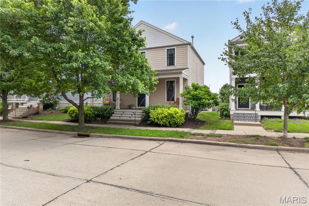 Located in the sought-after St. Charles New Town community on a premium lot. This beautiful 4-bedroom, 2.5-bath home offers 2,140 sq ft of stylish living space and is just steps away from the water. Main level features 9ft ceilings, dining room, breakfast room, Office & living room; both with custom built-in cabinets, & laundry/mud room. Engineered wood flooring on the first floor and the interior has been painted. The gourmet kitchen is designed to impress with granite countertops, tile backsplash, large center island, 42" cabinets with crown molding, spacious pantry, and stainless steel appliances. The 2nd level master suite offers a walk-in closet and private bathroom w/ a double sink vanity and soaking tub. There are 3 additional spacious bedrooms and hall bath. Enjoy relaxing on the full front porch or the side patio. Basement features rough in for bathroom and egress window. A perfect blend of comfort, charm, & modern finishes in one of St. Charles' most desirable neighborhoods.