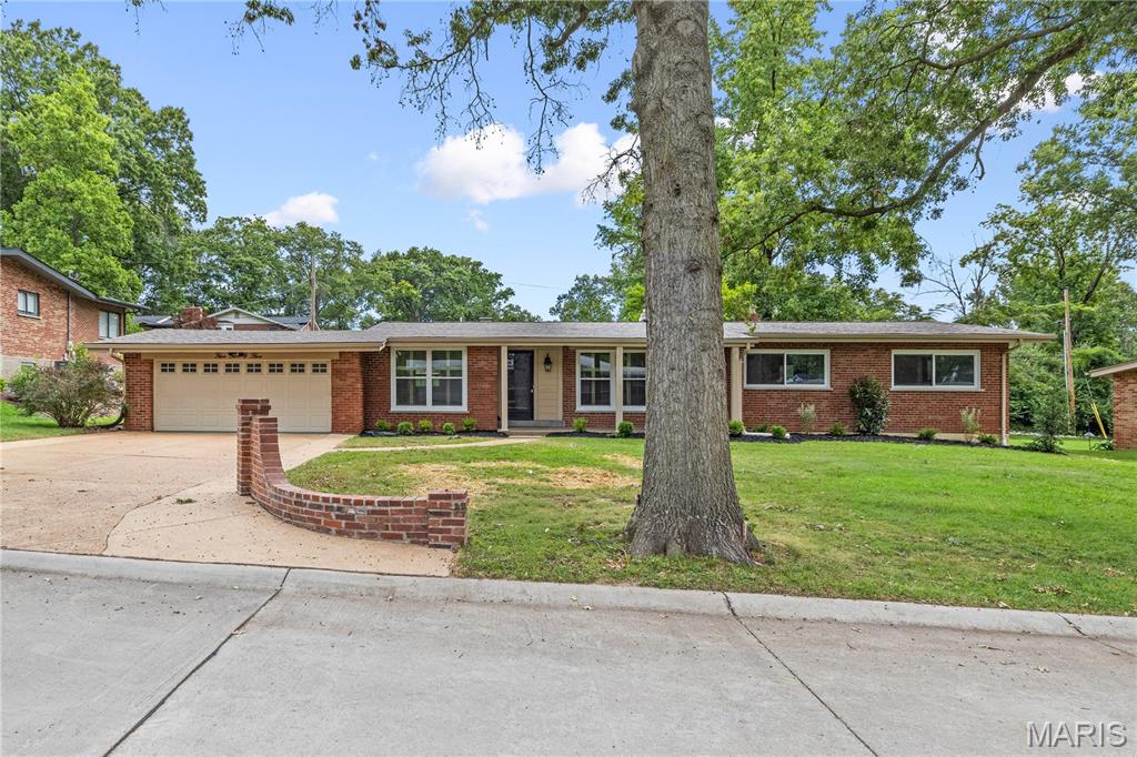 Welcome to this beautifully renovated brick ranch in Warson Woods! Located on a lovely tree-lined street, the home has great curb appeal with new windows and landscaping, a large covered porch, and charming light-topped brick pillars flanking the driveway. Inside, the vaulted living room features recessed lighting, plantation shutters, and gleaming hardwood floors that continue through the main level. You’ll love the kitchen updates: quartz counters, white cabinets with crown molding, timeless white subway tile backsplash, stainless steel appliances, and brushed gold fixtures. Off the breakfast room is a convenient laundry room. Enjoy hosting gatherings in the spacious dining room with a corner fireplace and sliding glass doors leading to the backyard. The primary bedroom has a walk-in closet and stunning en-suite bathroom with gorgeous tile-work on the floors and around the step-in shower, plus brushed gold fixtures and stylish lighting. Two more bedrooms, another full bath with tile-surround tub and quartz vanity complete the main level. The finished basement adds a 4th bedroom, bathroom with step-in shower, large rec room, bonus sleeping area or office, and room for storage as well. You’ll love spending summer in the fenced backyard, grilling with friends. The two-car garage has its own entrance to the backyard for easy storage. Just moments from Warson Woods Swim Club and Royal Woods Park, all of the shops and restaurants along Manchester Road, as well as Webster Groves Schools, plus quick access to I-64, and nearby Kirkwood, Frontenac, and Clayton, this amazing home in a convenient central location is an opportunity you won’t want to miss!