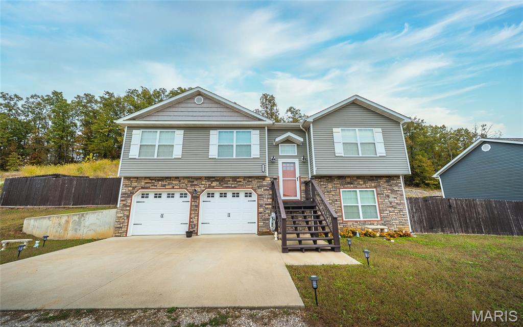 Welcome to this beautiful 4-bedroom, 2.5-bath home that perfectly blends comfort, craftsmanship, and convenience. From the moment you step inside, you’ll notice the custom details that make this home truly special. The open-concept living area features a stunning wood beam ceiling that adds warmth and character, along with luxury vinyl plank flooring that provides both durability and style. The kitchen is designed for gathering, complete with a large island offering extra workspace and a breakfast bar for casual dining. The dining area flows seamlessly to the back deck, ideal for enjoying your morning coffee or entertaining guests while taking in peaceful views of the yard. The primary suite is a true retreat, featuring a gorgeous tiled walk-in shower and plenty of space to unwind at the end of the day. Each of the bedrooms offers comfort and privacy, with soft carpeting and ample closet space. Downstairs, the finished basement expands your living options with a cozy family room—perfect for movie nights or a home gym—plus an additional bedroom and a convenient half bath for guests. Situated on a quiet dead-end street, this property offers a serene setting while still being close to everything you need. Shopping, restaurants, and Fort Leonard Wood are all just minutes away, making it an ideal location for those seeking both tranquility and accessibility. Whether you’re looking for a place to grow, entertain, or simply relax, this home has something for everyone.