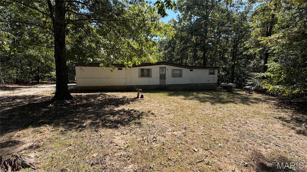 Check out this really nice 8.7 +/- acre property just North of Doniphan. It connects to Gov't ground in the back and has a good working private well along with a 2 bed 1 bath mobile home and other out buildings for storage and a really nice concrete storm cellar! The barn in the back is perfect for the start to a little farm and the large storage building used to be shop with electric and wood stove! Property is being sold with most contents in home and out buildings. This property would also be a great spot to build a home one day! Property comes with full working surveillance system. Call today to setup your showing. 
Seller requires conventional loan pre-approval or proof of funds before showing.