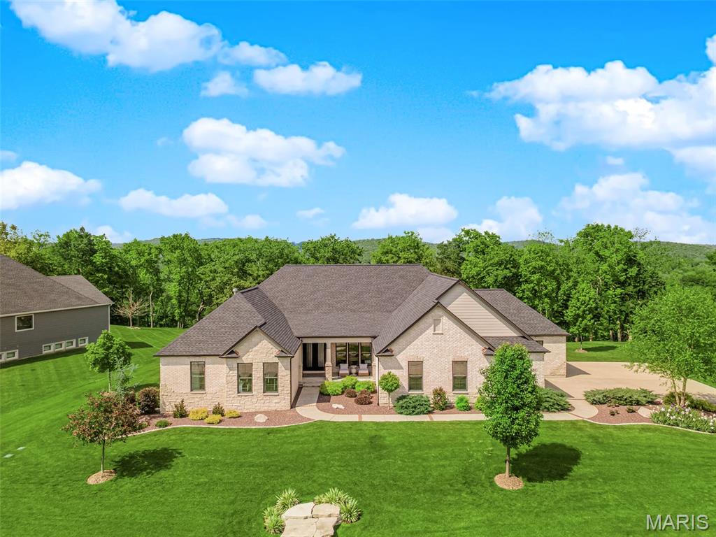 Welcome to luxury living in the highly sought-after, gated golf course community at Pevely Farms! This stunning home offers lake views, a new roof (Oct ’24), and full brick/stone exterior with James Hardie siding. A brick ribbon driveway leads to a 4-car extended finished garage w/ 9’ doors. Enjoy beautifully landscaped outdoor living w/ multiple seating areas, including a brick-paved fire pit area. Inside, the open floor plan features LVP flooring, 8’ doors, 7” baseboards, and great room w/ 12’ ceilings, custom window treatments, and a dry-stack fireplace w/ custom built-ins. The gourmet kitchen boasts a marble island, quartz counters, Sub Zero fridge, JennAir appliances, wine fridge, and large walk-in pantry. The primary suite includes custom window treatments, custom closet system and a luxurious bath w/ soaking tub. The finished lower level is perfect for entertaining w/ a theatre room, wet bar, pool table, spacious guest bedroom, and walk-in shower. This home is a true DREAM HOME!