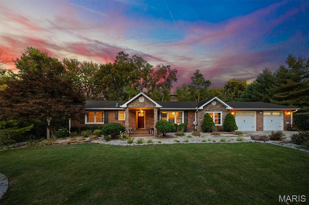 Experience the perfect blend of craftsmanship, comfort, and serenity in this stunning all-brick and stone ranch on Glen Crossing Road. This 4-bedroom, 2-bath home showcases beautiful hardwood floors, intricate tile work, and exceptional soundproofing throughout. Enjoy breathtaking sunrise and sunset views from the expansive backyard overlooking mature trees and acreage. The walk-out lower level includes a custom-built, sound-insulated theater room crafted by a professional from the entertainment industry—offering true cinematic quality. Additional highlights include a formal dining room, laundry with hidden safe area, and an oversized two-car garage with finished Creative Concrete flooring. Relax by the wood-burning fire pit or take in the peaceful setting from the patio. Ample parking to the south and northwest sides makes this property perfect for entertaining. Quality construction at an incredible value. Additionally, the garage does have added plumbing for a 3rd bathroom.