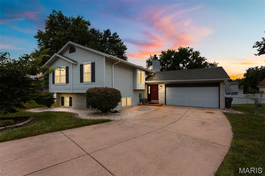 Fall in love with this spectacular split-level charmer! Enjoy the premium modern updates in this spacious 2,046 sq ft 4-bedroom, 2-bathroom home! Featuring an oversized 2-car garage, fully fenced yard, and a finished walk-out lower level, this property is packed with recent high-quality improvements. The open, vaulted main floor features a striking center beam, streams of natural light, gleaming wood floors, 2 skylights, and 2 cozy fireplaces. The gorgeous kitchen has been beautifully upgraded with new ceramic tile flooring, a new dishwasher, a newer garbage disposal, and a massive custom 50” x 75” butcher block island with extra built-in storage. Enjoy a versatile dual-suite layout, including a magnificent lower-level master with a walk-in closet and bath. The inviting lower-level family room includes a sleek wet bar and wine rack. Rest easy knowing the home features an HVAC system that was updated during the current ownership and a newer sump pump! Outside, the relaxing patio is perfectly framed by stunning backyard hardscaping and decorative stones. A must-see!