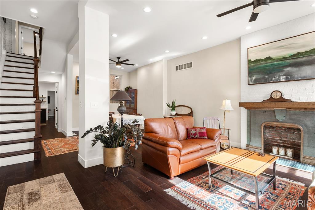 Price improvement, now offered at $569,000. Beautifully updated 3 bed | 2.5 bath | 10 rooms | 2,625 sqft. historic townhome in one of St. Louis’ most sought-after neighborhoods, just steps away from Lafayette Square Park, restaurants, and shops. Blending timeless architectural character with thoughtful modern upgrades, the current owners have invested over $130,000 in meaningful interior and exterior improvements.

The light-filled main level features soaring ceilings, exposed brick, engineered wood flooring, recessed lighting, and an open yet defined layout ideal for daily living and entertaining. The family room flows into the breakfast area and formal dining space.

The galley kitchen offers stainless appliances, custom cabinetry, open shelving, farmhouse sink, and generous prep space, designed for both function and style.

The second level includes a spacious guest bedroom, laundry room, and a stunning primary suite with custom ensuite bath featuring tile flooring, dual vanity, walk-in shower, and clawfoot soaking tub. Custom Elfa closet systems maximize storage throughout.

The third floor provides an additional bedroom, office or flex space, and full bath, ideal for guests, remote work, or creative use.

Interior upgrades include stabilization of the third-floor staircase with the installation of a newel post, new tile flooring in the half bath, a custom under-stair bar, and a stunning living room fireplace mantel that blends historic character with craftsmanship. The fireplace surround was created using reclaimed stone salvaged from the cellar, while the wood mantel and trim were custom-built to complement the home’s architectural style.

The backyard has been completely transformed from mud and straw into a true outdoor living space, now featuring a brick patio, professional landscaping, privacy fencing, and an oversized two-car concrete parking pad. A custom-built St. Louis City garage with an electric overhead door faces the alley, providing both the convenience and appearance of a garage.

Additional exterior updates include a new TPO roof, wrought iron front stair handrail and cellar window bars, front and rear landscaping with stone and brick walkways, exterior painting, and a Level 2 electric vehicle charger.

A rare opportunity to own a move-in ready home where historic charm meets modern convenience in an unbeatable Lafayette Square location.

Wine cooler, along with the refrigerator, washer, dryer, and stove currently in the home, are included in the sale.

Note: For comparison to the 2022 purchase, MLS #22007124 shows the prior backyard, living room, and earlier roof condition.