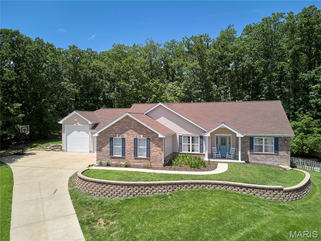 Exceptional Atrium ranch on a private wooded one acre lot backing to trees with a 6 car garage spaces.  There are 3 bedrooms plus an office with glass french doors on the main level.  Updated and remodeled through out. Outstanding kitchen with SS appliances, gas stove, beauitful cabinets, granite counters and plenty of storage.  Great Room w/gas fireplace, open floorplan with a wall of windows looking out to trees and patios. Primary bedroom w/bay window, vaulted ceiling, ceiling fan. En-suite bath with double vanity, touch mirror with LED lighting and walk in organized closet. Lower Level family room  w/gas fireplace is great for entertaining with a walk behind wet bar with counters, cabinets and a storage closet. Family room waks out to the HOT TUB and patios.  There is also a room 24 x 17 being used as a game and media room. Over 3300 SF of Luxury Living Space!
A large unfinished storage room  connects to a workshop with stairs to the big garage! Big garage is 31 x 30 that can store every toy you own in the 4+-car garage with an RV height door bay. AND an oversized 2 car to the main level of the house!  Quick access to major highways, shopping, dining and AAA rated Rockwood Schools.