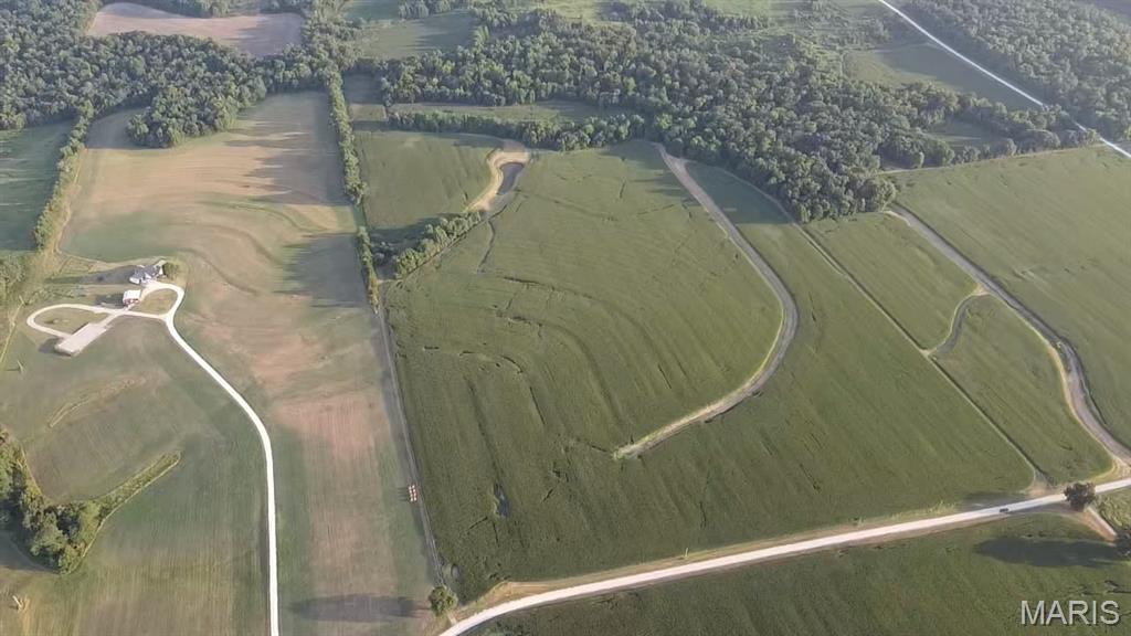 Located just 6 miles East of Vandalia, Missouri, this 135+/- acre farm offers a rare combination of productive row crop ground and trophy whitetail hunting all in one tract. 107+/- tillable acres have been in a corn/soybean rotation and boast a weighted farm NCCPI of 72.21, reflecting highly productive soils across the property. Beyond the tillable acres, the farm offers excellent recreational value. A small pond and a creek running along the south side provide water sources for wildlife, and the mix of timber and creek-bottom ground makes this a strong deer and turkey hunting property. A small cabin on-site is equipped with heat and air, offering a comfortable base camp for hunting season or weekend getaways. The property is naturally divided into two parcels by a county road running through it (55.61+/- acres and 81.96+/- acres), offering flexibility for a future owner. Gravel road frontage provides easy access to the farm year-round. If you're looking for a productive investment opportunity, a recreational retreat, or both, this Pike County farm checks every box.