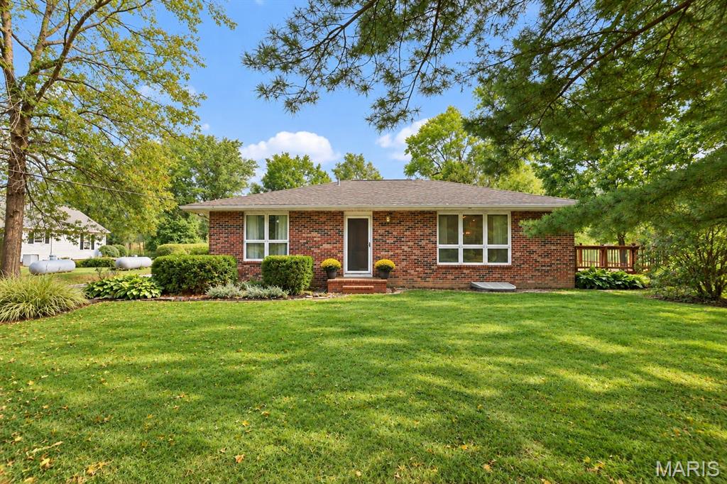 The space you’ve been looking for with endless possibilities! This 2,481 SF all-brick ranch offers the perfect blend of rural tranquility, spacious living with 3 bedrooms/3 bathrooms. Situated on 1 acre with a wooded tree line along the back of the property, this home provides privacy and room to enjoy the outdoors. Inside, the quaint living room features beautiful solid wood floors, while the remodeled eat-in kitchen offers a center island, updated Corian countertops, and direct access to the impressive 27 x 11 deck—perfect for entertaining or relaxing while taking in the peaceful surroundings. Two updated bathrooms are located on the main level, along with a spacious laundry room/mudroom for added everyday convenience. The lower level provides an abundance of additional living space, including a family room, office space, 3/4 bathroom, and a bedroom with an egress window. The flexible layout offers plenty of options for guests, hobbies, work-from-home space, recreation, or additional living needs. The property features a 2-car attached garage PLUS a rare 29 x 23 heated detached garage. Whether you need space for extra vehicles, recreational toys, equipment, or a workshop, this oversized heated garage offers exceptional versatility. Conveniently located just outside Edwardsville with easy access to the interstates, SIUE, new developments, shopping, dining, MCT bike trails and area amenities, all while enjoying the feel of country living. A rare opportunity for acreage, flexible living space, and two garages in a convenient location!