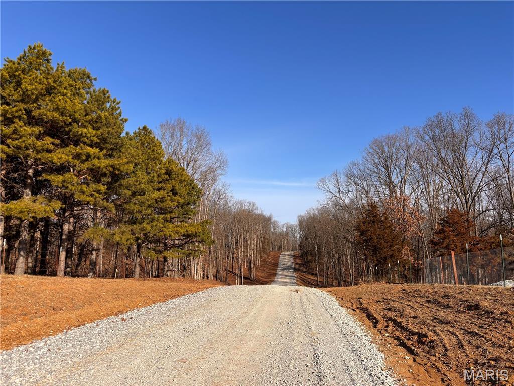 5 ACRES-SCENIC WOODED LOT-PERFECT SETTING FOR YOUR CUSTOM HOME OR BARNDOMINIUM!!! Welcome to Klausmeier Trails, featuring 10 scenic wooded lots ranging from 3 to 5 acres. Cuivre River Electric will be available upon completion of engineering. Each lot will require its own well and septic. Light restrictions apply—including no mobile or modular homes, no junk yards, no hog farms. HOA/Assessments-TBD. Enjoy peaceful country living with easy access just off blacktop and only minutes from I-70.
