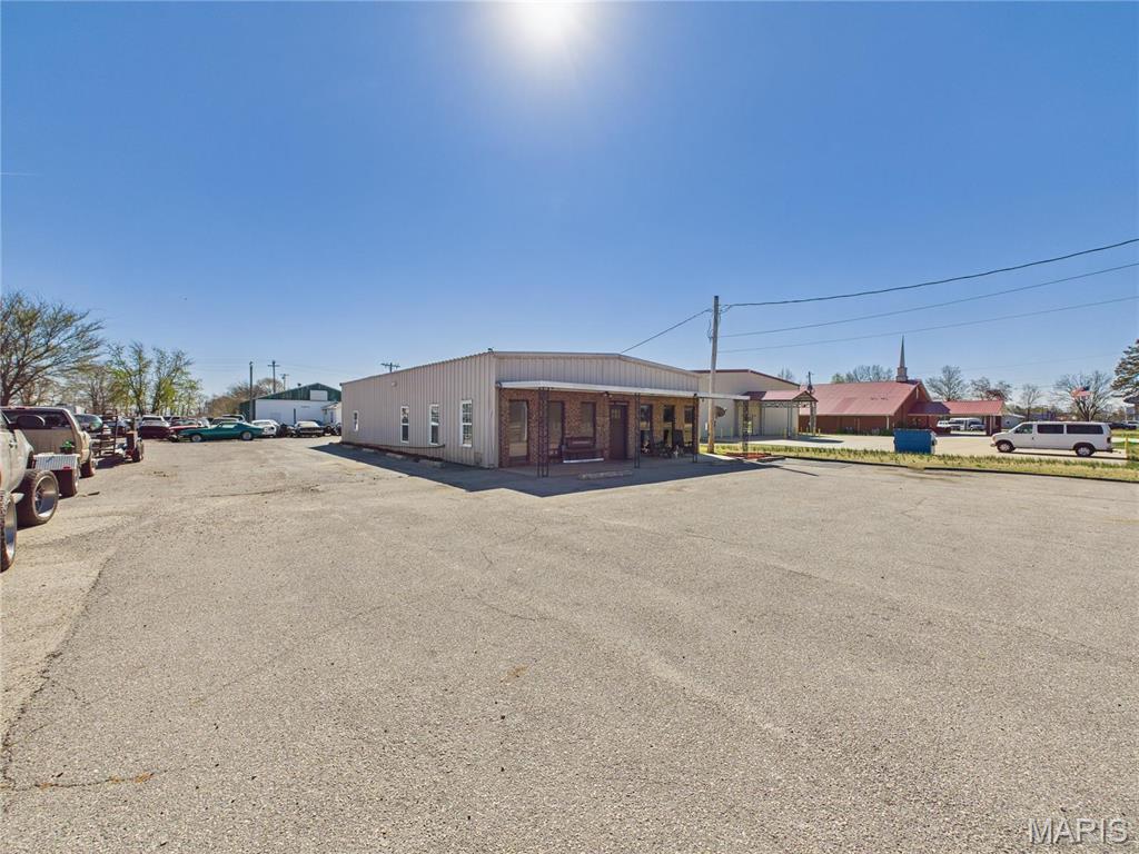 Positioned along highly trafficked Highway 25, this mixed-use commercial property at 2890 N. Douglass Street in Malden, Missouri offers exceptional visibility and versatility for a wide range of business opportunities. The front building features inviting storefront space ideal for retail or client-facing operations, along with multiple office areas perfectly suited for independent agents or professional services. In the rear, the property expands to include ample space for storage, workshops, or automotive maintenance, making it a strong fit for both service-based and operational businesses. With its flexible layout, high exposure location, and partial chain-link fencing along the side and rear, this property is well-equipped to support a growing enterprise or serve as a strategic investment with multiple income streams.