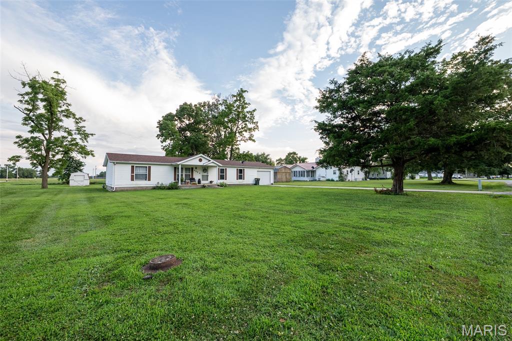 Welcome to this spacious home offering over 1,680 square feet of living space on nearly half an acre in Patoka! Currently configured as a 2-bedroom, 2-bath home, the oversized second bedroom was originally designed as two separate bedrooms and could easily be converted back into a 3-bedroom if additional space is needed.

Inside, you’ll find a large living room, an inviting family room with cathedral ceilings, and a spacious kitchen featuring an island and ample cabinet space. The primary suite has been thoughtfully updated with a beautifully remodeled en-suite bathroom, including a large walk-in closet in place of the former garden tub, creating a more functional and modern layout. New flooring throughout much of the home gives the interior a fresh, updated feel.

Step outside and enjoy the covered front porch, rear deck, and expansive yard with plenty of room for entertaining, gardening, or simply relaxing. An attached garage provides additional storage and convenience.

If you’ve been searching for an affordable home with generous living space, modern updates, and the flexibility to add a third bedroom, this property is one you won’t want to miss. Schedule your private showing today!

FYI: AGENT OWNED HOME