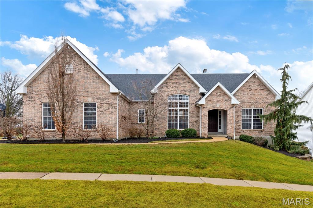 This spectacular atrium ranch features distinctive design elements and builder upgrades throughout, including oak hardwood floors, soaring ceilings, and large windows that draw in abundant natural light. An impressive foyer leads to a well-appointed study, a formal dining room framed with a cathedral vault, and a stunning great room with a dramatic wall of windows showcasing private wooded views. The custom-designed kitchen features white cabinetry, granite countertops, and stainless steel appliances, and adjoins a bright breakfast room with atrium doors that open to an outstanding screened-in porch. The primary bedroom suite includes a luxurious spa-style shower bath, while a second bedroom and full hall bath complete the main-floor living quarters. The lower-level entertainment space showcasing a 9' pour includes a spacious recreation room with a brick fireplace, a game room, and two additional bedrooms with a full hall bath. Situated on a .25-acre cul-de-sac lot, the property also features a deck, patio, and a three-car garage.