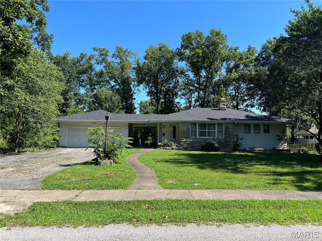 Welcome home to this charming 3-bedroom, 1-bath residence situated on a spacious 0.68-acre lot in the peaceful town of Benton. With plenty of room to spread out both inside and out, this property offers the perfect blend of comfort, convenience, and outdoor living. The large, fenced backyard provides a safe space for children and pets to play freely, while the walk-out basement opens to a beautiful stone patio—ideal for summer evenings, backyard barbecues, and entertaining family and friends. Inside, you'll find hardwood floors throughout, a spacious living room filled with natural light from a large picture window, and scenic views of the surrounding neighborhood. A 2-car attached garage offers plenty of storage and convenience, with a covered patio connecting the garage to the home to keep you sheltered from the elements year-round. Located just minutes from downtown Benton, this home is only a 3-minute drive to the hospital and conveniently situated near local schools, making it an excellent choice for anyone seeking a quiet neighborhood with easy access to everyday amenities. Sold As-Is. New roof and basement patio door in 2025 and updated plumbing in basement to the kitchen.