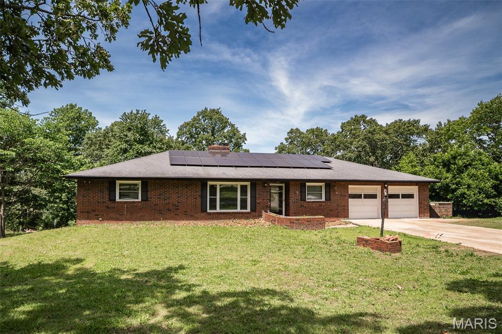 Opportunity awaits with this spacious home situated on a picturesque 1.6-acre lot in a desirable, established neighborhood just minutes from downtown. Packed with potential for investors or buyers looking to build sweat equity, this property offers solid features and plenty of room to make it your own. Mature trees provide shade and privacy, while the oversized circular driveway allows for ample parking. Inside, you'll find generous living spaces, two wood-burning fireplaces, a large kitchen with abundant counter space, spacious bathrooms with deep soaking tubs, and a full walkout basement ready for additional finishing or storage. The massive screened-in porch is perfect for relaxing or entertaining, and the finished bonus room off the garage offers flexibility for a home office, guest space, or hobby room. Energy-saving upgrades include 26 solar panels installed in 2021 and added attic insulation. Property is being sold as-is.