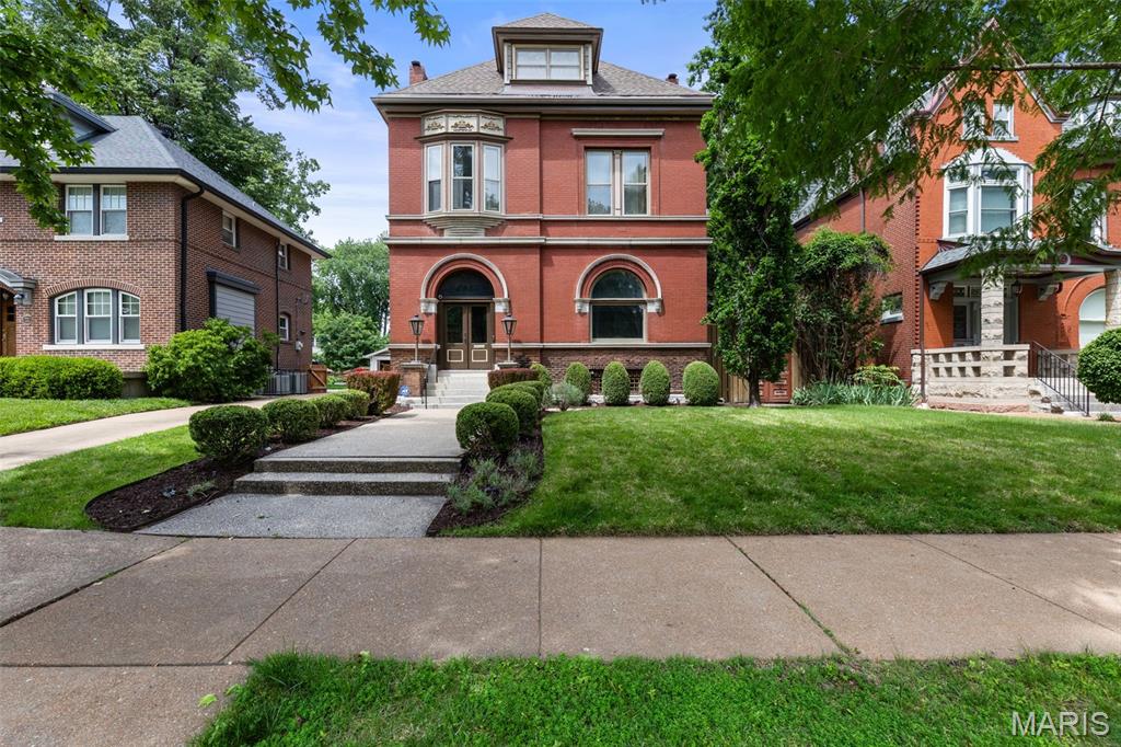 Own a piece of St. Louis history in the heart of Compton Heights. Designed by noted architect Ernst C. Janssen, architect of the famed Magic Chef Mansion, 2935 Russell Boulevard is believed to be his second commissioned residence in Compton Heights. Janssen would go on to design at least 14 homes here, becoming a significant contributor to the look and character of the neighborhood. From Victorian and Renaissance Revival to Tudor and Colonial influences, no two are quite alike, creating a remarkable collection of Janssen’s work tucked throughout the winding streets of Compton Heights. And here’s where it gets exciting: there are only so many Janssen homes to own. Each was individually commissioned, each tells a different chapter of his career, and they simply don’t come to market on demand. At $875,000, 2935 Russell presents a rare chance to own one of his earliest Compton Heights commissions at an entry point increasingly difficult to find among the neighborhood’s grand residences. More than a beautiful historic home, it’s one piece of a finite architectural collection. Once it finds its next steward, who knows when another opportunity like it will come along. More than 130 years later, an extraordinary amount of the home’s original craftsmanship remains. Nearly every piece of stained glass is original to the home, with the exception of one window that was faithfully recreated to replicate the original design. Intricate millwork, pocket doors, soaring ceilings and a grand staircase set the tone, while smaller discoveries tell just as much of the story. The original butler’s call system remains, and the butler’s pantry retains its original sink with brass legs, reminders of how this home functioned at the turn of the century. These aren’t details added later to make a house feel historic. They are surviving pieces of the home’s original late 19th century craftsmanship. Generously scaled living and dining rooms are connected by original pocket doors, creating gracious spaces for both everyday living and entertaining. Tall windows bring in abundant natural light, while the kitchen and butler’s pantry bridge the home’s history with modern functionality. The primary suite takes things to another level, literally, with an entire floor dedicated to the owner’s retreat. Cork flooring leads to a spa like bath with heated floors, dual faucets, soaking tub and steam shower with built in bench, plus a generous walk in closet. It’s a modern retreat tucked inside a home that has retained so much of its original soul. Outside, a beautiful fenced yard offers stone patio areas, low maintenance turf for kids and pets and a working outdoor fireplace that creates a natural gathering spot. A two car garage provides convenient off street parking and additional storage.
And then there’s Compton Heights itself. Winding boulevards, landscaped medians, generous setbacks and individually commissioned residences make it unlike almost anywhere else in St. Louis. 2935 Russell offers the increasingly rare combination of architectural provenance, preserved craftsmanship, modern livability and one of St. Louis’ most distinctive historic neighborhoods.