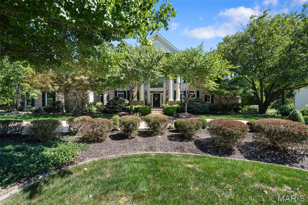 Welcome to this expansive and beautifully appointed home nestled on a private, 1.16-acre lot in a prestigious neighborhood. Step inside to a dramatic two-story great room featuring a stunning wall of windows that floods the space with natural light. The heart of the home is a spacious kitchen/hearth room, outfitted with custom 42-inch cabinetry, top-of-the-line appliances, a center island, walk-in pantry, and a cozy breakfast room. A see-through gas fireplace adds warmth and charm to both the hearth room and adjoining living areas. The main floor boasts a luxurious primary suite complete with a private library, dressing room, dual custom closets, and a spa-like bath featuring a steam shower and jetted tub. A convenient main-floor laundry adds to the home's thoughtful layout. Upstairs, you'll find three generous bedroom suites and a large bonus room/flex space perfect for a playroom, office, or den area. The expansive lower level offers an additional 2,000 square feet of living space, including a full kitchen, wet bar, family room, media room, office, exercise room, & a fifth bedroom suite—ideal for guests or multi-generational living. Outdoor living is equally impressive with two decks and a lower patio overlooking the beautifully landscaped, private yard, full of possibilities for outdoor entertaining. An oversized 4-car garage completes this exceptional property. This home combines luxury, space, and versatility in a peaceful, sought-after neighborhood—truly a rare find.