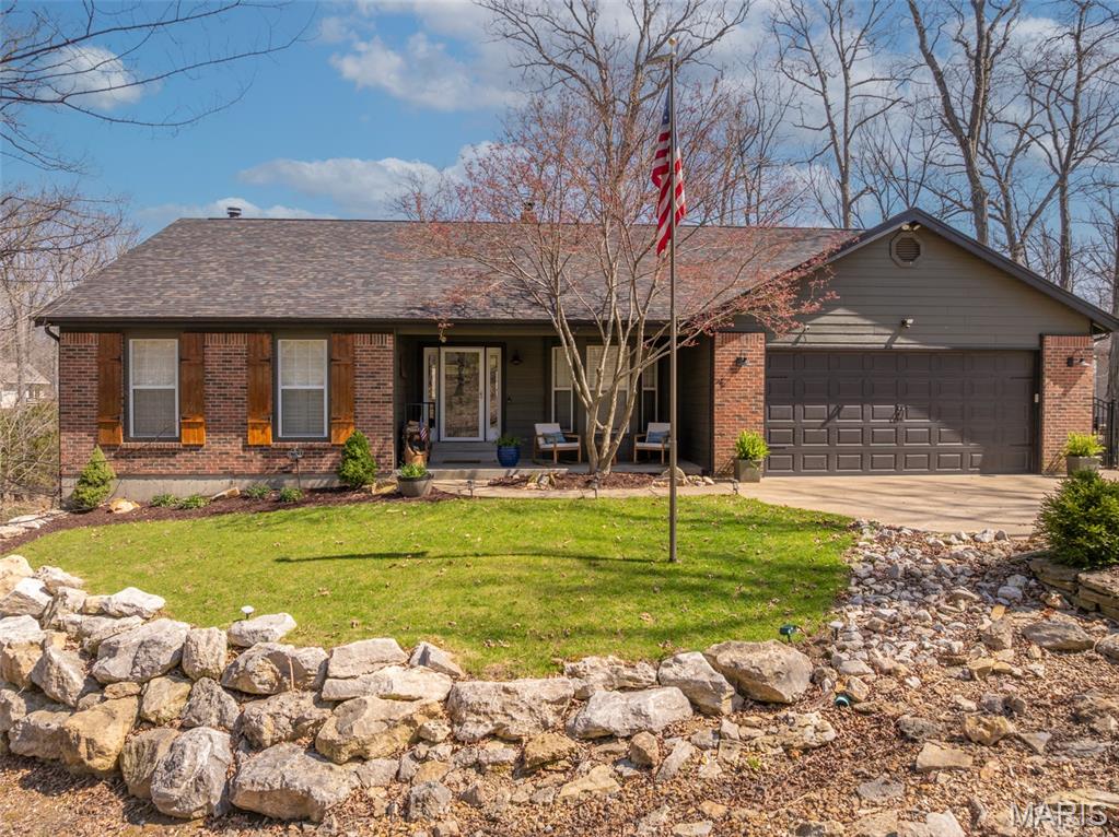 Experience the perfect blend of rustic charm and modern comfort in the beautifully updated waterfront retreat on Lake Lorraine, featuring 75+ feet of private shoreline and its own dock on a recently dredged lake with excellent water depth-all capturing the authentic Innsbrook feel.  Southeast exposure fills the home with warmth morning sunlight and abundant natural light.

The open living area feature custom cabinetry, intricate woodwork, and stunning floor-to- woodburning fireplace. Enjoy panoramic lake views from the four seasons room or step onto the private deck overlooking the water.  The covered dry patio below stays from runoff and rain offering use during incumbent weather.

The upstairs primary suite offers a large walk-in closet and spa-like bath with a stand alone tub and separate shower. Main level includes an office/rec room or an additional bedroom, laundry, and garage access to a heated shop. Downstairs features 2 bedrooms, full bath, wet bar, living area, and a walkout to the lakeside sitting and fire pit area including a dock for easy water access. Family lake living at its best!