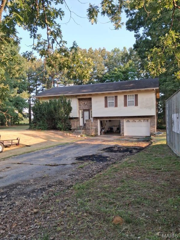 What a beautiful piece of property! This 3 bedroom, 2.5 bath home sits on 6 desired acres, just outside Doniphan City limits. The pasture ground would be a great place for a horse or mini farm! There is a shop on the premises with full utilities! The home as a 2 car garage on the lower level with ample room for large vehicles. There are 2 bedrooms up stairs with 1.5 baths and 1 one bedroom, a family room and 1 full bath on the lower level. On the lower level, you'll find a wood stove that would be nice for cold winter evenings! The roof was replaced in 2018 along with the HVAC unit. The house could use some TLC but it is livable as is! Schedule your showing now! By appointment only.   INTERIOR PHOTOS COMING SOON