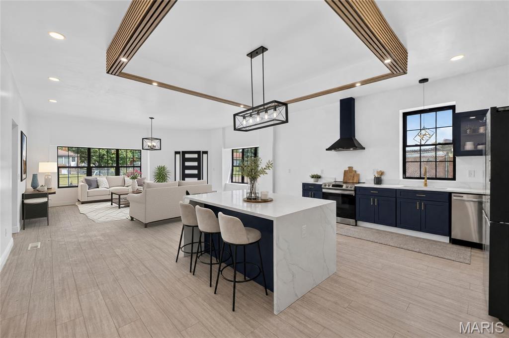 Welcome to 701 Reed Avenue—a stunning, top-to-bottom renovation where modern design meets everyday functionality. Situated on a desirable corner lot, this completely re-imagined home offers a split floor-plan consisting of 3 bedrooms, 2.5 beautifully renovated bathrooms, and a bright, open-concept layout.

Oversized black-framed windows fill the home with natural light, while new flooring, statement lighting, and a striking architectural ceiling detail create an elevated, contemporary feel. The showpiece kitchen features rich navy cabinetry, sleek counter-tops, stainless-steel appliances, a brand-new refrigerator, and a jaw dropping waterfall-edge island with generous seating.

The improvements extend well beyond the finishes, including a new roof, windows, doors, electrical panel, electrical throughout the home, kitchen, bathrooms, flooring, and more. An attached tandem garage provides plenty of room for parking, storage, and a dedicated workshop or project space.

Outside, the spacious backyard offers room to entertain, play, garden, or relax. Stylish, functional, and truly move-in ready—701 Reed Avenue is the complete package! Ready to call HOME.