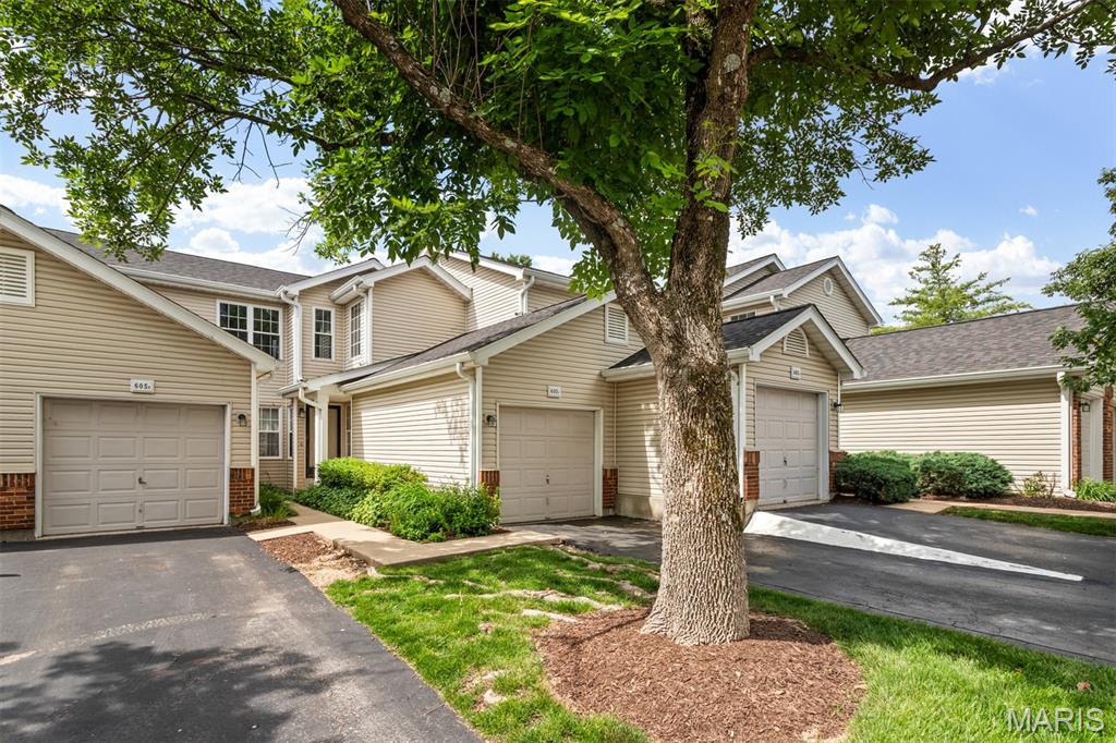 Enjoy peaceful wooded views from the deck of this well-maintained Woodside Trails condo. This 2-bedroom, 2-bath home offers an open floor plan with a wood-burning fireplace, an attached one-car garage, and a main-floor laundry room with a newer stainless-steel washer and dryer included. The kitchen features generous cabinet and counter space, a pantry, white cabinetry, subway tile backsplash, and an open breakfast bar. The refrigerator is included! The primary suite includes updated flooring, a large closet, plus a beautiful view overlooking the wooded common ground.  The Primary Bath features a double vessel sink vanity, large shower, a huge linen closet and access to the laundry room.  The second bedroom also offers a double closet for additional storage. The second bath has tub/shower combo! The HVAC system and water heater were replaced in Spring of 2026.  Roof was replaced in 2024.  Seller is offering buyer the Enhanced Assurant Home Warranty plan ($620).  Move in with confidence that systems have recently been replaced, and appliances are covered under the warranty! Enjoy the amenities of this beautiful complex with pool, clubhouse and tennis court! The condo is located on the upper level and does require walking up steps from the entry foyer/garage area to get to the unit.