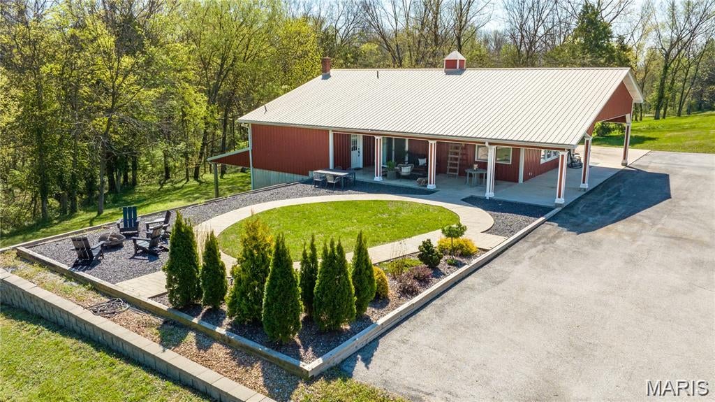 This Augusta gem is pure wine country magic — with serious style. Set on nearly one and a half private acres in the heart of charming Augusta, Missouri, 162 Jackson Street is a rare, turn-key completely furnished retreat that blends small-town character, natural surroundings, and a polished, high-style interior that feels more like a boutique getaway than a typical weekend house. Currently operating as a highly rated, income-producing short-term rental, the home is perfectly suited for winery weekends, weddings, Katy Trail riders, girls’ trips, family getaways, and easy escapes from St. Louis -- or as a full-time, move-in ready residence. Inside, the home is absolutely unforgettable. The huge open floor plan features 14’ ceilings, industrial details, heated concrete floors, a dramatic fireplace, custom finishes, a 50-square-foot butcher block island, barn door accents, cozy bedrooms, and a spa-like walk-in shower. The result is a space that feels stylish, comfortable, memorable, and perfectly designed for gathering. The location offers the best of Augusta wine country living. Shops, restaurants, wineries, trails, and event venues are walkable or just a quick drive away, while the home itself offers a peaceful private setting with beautiful views of nature. Take your pick of outdoor sitting areas for morning coffee, an afternoon glass of wine, or quiet evenings after a day exploring Augusta. With fiber-optic internet, generous parking, room for recreational vehicles, and space for future expansion, the property offers both charm and practicality. Keep it as an income-producing short-term rental, make it your personal weekend retreat, or settle in full-time and enjoy the charm of one of Missouri’s most beloved small towns.