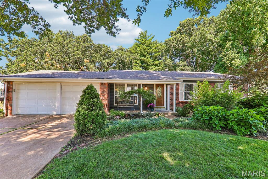 Spacious living and room for everyone await you in this Manchester, MO home! Located in the desirable Country Lane Woods subdivision, this 5-bedroom, 3-bath home offers plenty of space both inside and out. Upon entering, you'll find beautiful wood floors in the living room and throughout much of the main level. The dining area is adjacent to double sliding glass doors that fill the space with natural light and provide access to the deck. The primary bedroom includes a private full bath with shower, while three additional bedrooms and another full bath complete the main level. The finished lower level is a walk-out and offers even more living space with a large rec room, family room w/ wood burning stove, fifth bedroom w/ walk-in closet, full bath, laundry area, and multiple storage areas. Outside, enjoy the deck overlooking the shaded and private backyard with playset area and walk-around sidewalk for convenience . Additional features include a 2-car attached garage, newer siding, newer AC, and a roof that is only 2 years old. Country Lane Woods amenities include a community pool, clubhouse, pickleball courts, playground, and picnic area. Conveniently located near shopping, restaurants, parks, and everything Manchester has to offer!