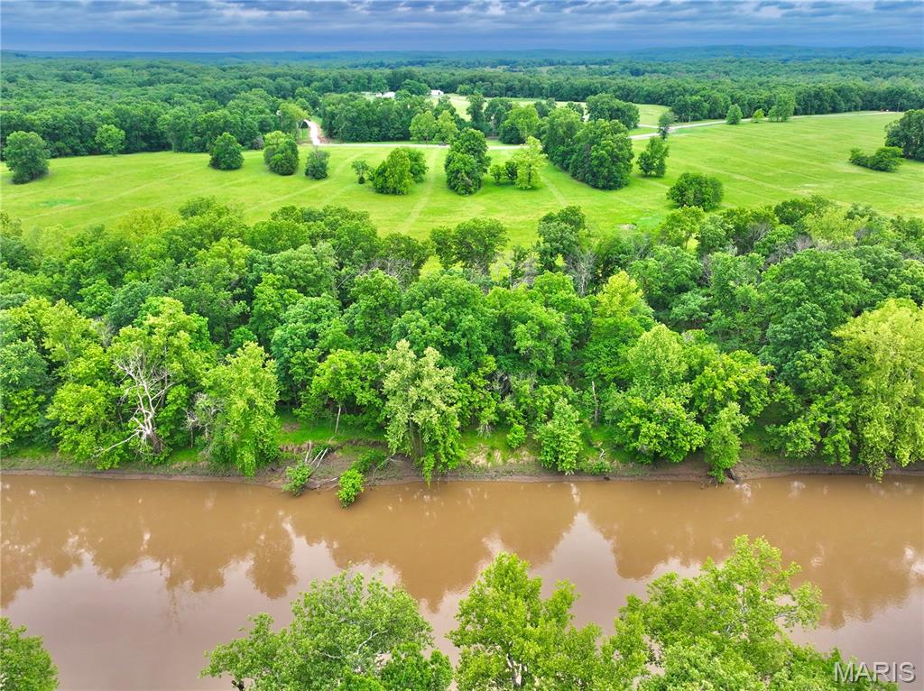 Discover the perfect blend of privacy, recreation, and riverfront beauty with this exceptional 6.5acre property on the Sac River. Featuring 359+ feet of private river frontage and an additional deeded river access point just upstream, this tract offers multiple ways to enjoy one of Missouri’s most scenic waterways.

The property boasts a beautiful mix of open ground and mature timber, creating an ideal setting for a future home, cabin, or weekend getaway. Towering hardwoods line the riverbank, providing abundant shade, stunning natural beauty, and easy access to the water with minimal underbrush. Whether you’re fishing, floating, swimming, or simply relaxing by the river, you’ll appreciate the peaceful atmosphere and picturesque views this property delivers.

Buildable acreage located outside the floodplain provides flexibility for development, while available electric service makes the property even more ready for your plans. Trees border three sides of the tract, enhancing privacy and creating a secluded setting rarely found on smaller riverfront parcels.

Conveniently located at the end of a dead-end county road and less than two miles from Highway 54, this property offers excellent access while maintaining a quiet and private feel. A gated entrance provides both security and convenience, and the well-maintained private road ensures easy year-round access.

With additional adjoining acreage available for purchase, this is a rare opportunity to own a highly desirable stretch of Sac River frontage with room to expand. Whether you’re searching for a recreational retreat, future homesite, or investment property, this riverfront tract checks all the boxes.