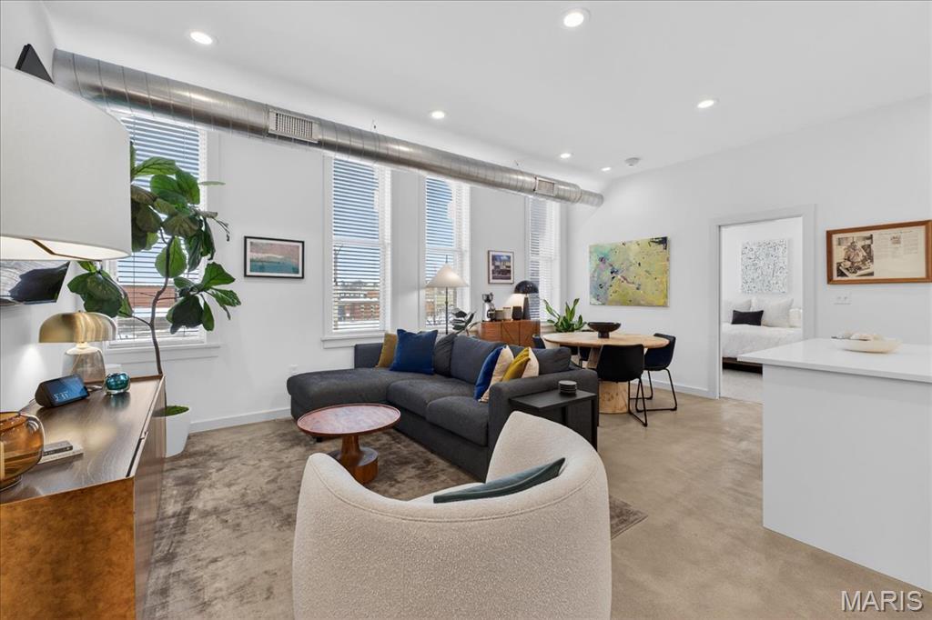 Welcome to your serene oasis at 3842 Unit 2A – one of only two condos crowning the historic Wolfner building in the On Olive community. Built in 2020, this modern home pairs the character of a vintage shell with a bright, contemporary interior. Step inside to a light-filled open plan: concrete floors, quartz countertops and GE Cafe appliances create a polished backdrop while north-facing windows bathe the living area in natural light. Two bedroom retreats are positioned for privacy, yet the generous living-dining space flows effortlessly for gatherings. Custom closet build-outs offer smart storage, and the mounted TVs in bedrooms and custom dining table stay with the home. A secure elevator brings you directly to your door, and your garage spot sits conveniently beside the pool. The HOA covers water, internet, trash, sewer and roof maintenance, giving peace of mind and low monthly costs; even the tax abatement keeps the property tax bill minimal. Beyond your doorstep, the community beckons with a gym, edible garden, dog run and lush private parks linked by meandering paths. Enjoy the resort-style pool with tanning deck, fire pit and grilling cabana, or walk to The Foundry, Alamo Drafthouse Cinema, the Contemporary Art Museum, Fox Theatre and numerous restaurants. Experience a blend of urban convenience, nature and community – an invitation to live beautifully in the heart of St. Louis.