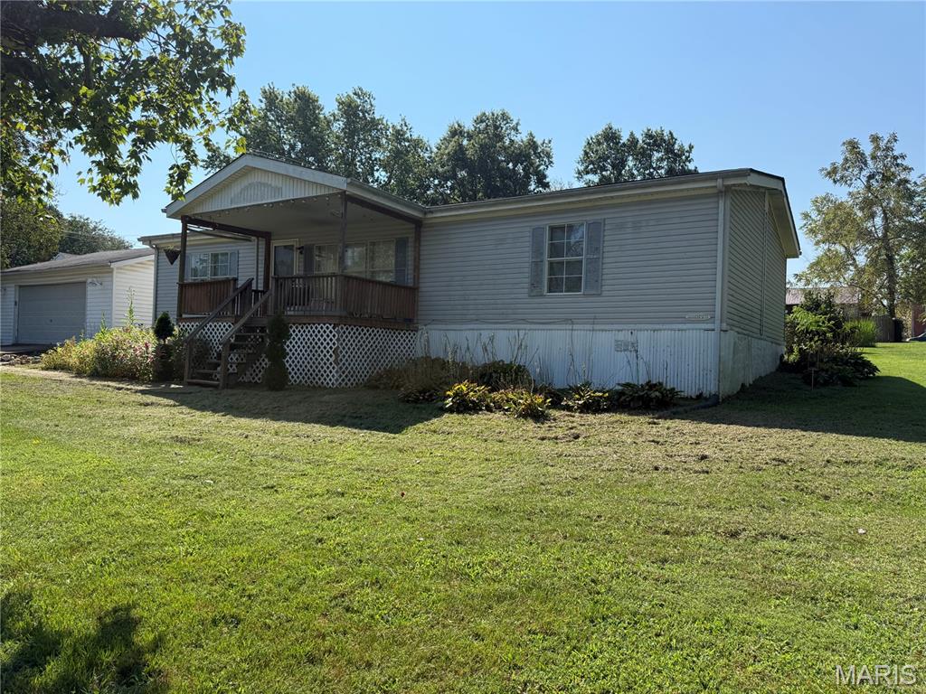 This mobile home, built in 1989, offers the opportunity to craft your ideal space fit to your style. Featuring a large main bedroom just off the living area with a large bathroom hosting an oversized tub and double vanity, as well as a walk in closet. On the other side of the house there is an additional full bathroom, and a second bedroom with a walk in closet as well, and a very spacious full bath attached. Outside this home features a deck on both the front and back side of the house with a good sized flat yard perfect for your outside activities. As you pull into the drive way you can also park in the oversized detached garage, providing great additional outside space, along with the tool shed in the back yard!  Schedule a viewing today and explore the possibilities this property holds!