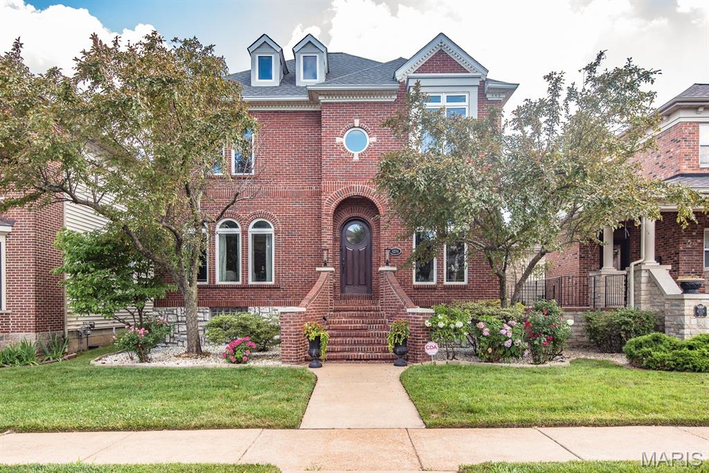 Nestled on a quiet one-way street in the beloved Gaslight Square, this 3 bed 3.5 bath home sits on a raised English basement. The perfect combo of suburban & city living. A stately brick front featuring a majestic brick staircase takes you to a beautiful custom 8ft wood door.Upon entry a 2-story foyer, neutral hardwood floors & lovely arches welcome you.The main floor boasts an elegant dining room w/tray ceiling & butler door, a spacious den w/built in bookcase, & glass french doors & a cozy family room w/showstopping stone fireplace & built in cabinetry & sound system. The gorgeous kitchen is a chef's dream! Plenty of storage & counter space, walk in pantry, sparkling stainless appliances, 6 burner stove & stone hood will wow your guests. Upstairs you'll find 3 bedrooms.The master has a sitting room, coffered ceiling, & fireplace. The master bath includes a washer/dryer, a vaulted window & a large walk in closet. The lower level has a rec room w/bar area and features custom murals that display the glimpses into the magic of the Gaslight Square. There's also a wine room, fireplace, sleeping area & full bath! The large composite deck overlooks the peaceful level yard with privacy fence. Bonuses include a sprinkler system in the front & back yard, a 2.5 car garage & short walks to your favorite central west end establishments.