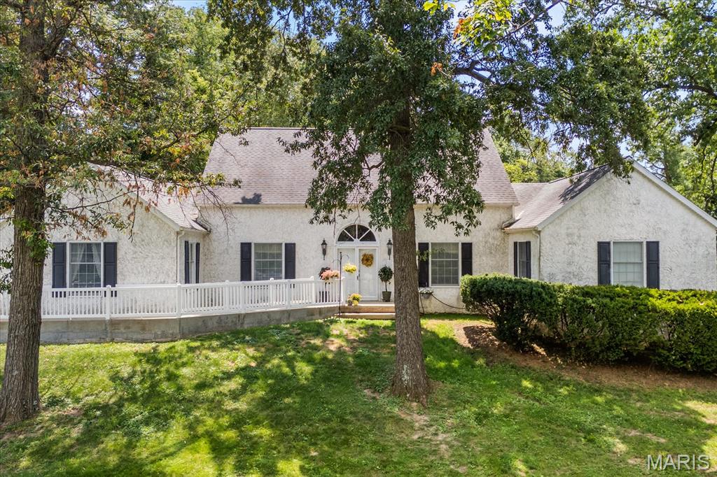 Tucked away on a private, wooded 3+ acre setting with its own stocked pond, this one-of-a-kind Swansea property offers an exceptional combination of space, character, privacy, and opportunity—all just minutes from everyday conveniences. With dual residential and commercial zoning, this impressive 3,428 sf stucco home provides the flexibility to enjoy a peaceful private retreat, create a distinctive live/work environment, or explore a variety of possibilities. A long, tree-lined drive leads to the home’s dramatic rooflines and welcoming covered entry. Inside, soaring vaulted ceilings, rich hardwood floors, and rustic wood beams immediately set this home apart. Adding an incredible piece of local history, some of the beams were salvaged from Swansea’s former railroad station, now home to LongStory Coffee.
The spacious eat-in kitchen features granite countertops, stainless appliances, a gas range, indoor grill, tile backsplash, built-in wine refrigerator, and a charming bay-window breakfast nook. Multiple dining and gathering spaces provide plenty of room for entertaining, while the inviting family room features a brick, wood-burning fireplace with gas starter for cozy evenings at home. Four spacious bedrooms and 2.5 baths include a generously sized primary suite, while the home’s flexible layout provides options for guests, multigenerational living, or dedicated office space. The setting is equally impressive. Step outside to expansive outdoor living areas overlooking mature woods and a private stocked pond alive with fish, turtles, and abundant wildlife. Relax on the multi-level deck, enjoy the picturesque garden, or simply take in the privacy and natural surroundings rarely found this close to town. Exceptional functionality continues with an oversized 3-bay tuck-under garage, abundant additional parking, a detached pole barn/outbuilding ideal for storage, hobbies, or equipment, a dedicated dog run, and an impressive 17x42 basement workshop with separate 100-amp electrical service. For those considering the property’s commercial potential, additional business parking is located at the upper portion of the property with an ADA-compliant path providing access to both entrances. Whether you’re searching for acreage and privacy, room for hobbies and projects, a distinctive home with local history, or the flexibility of a live/work property, this truly unique offering delivers possibilities that are difficult to duplicate. Enjoy the feeling of a secluded country retreat while remaining remarkably close to Swansea shopping, dining, and conveniences.   Sale includes two parcels. Parcel one 2.05 acres with 2025 tax of $8193 and owner occupied exemption; Parcel two 1.76 acres with 2025 tax of $1459 and no exemptions.