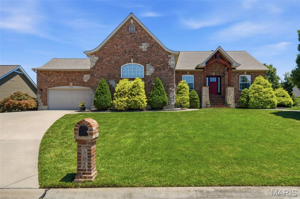 Welcome to this beautifully crafted custom atrium ranch offering over 3,000 square feet of finished living space. Vaulted ceilings, Brazilian cherry hardwood floors, and a stunning brick-and-stone fireplace create a warm, inviting atmosphere. The open kitchen features granite countertops, custom cabinetry, and a breakfast bar that flows seamlessly into the main living area. Relax in the spacious primary suite with a whirlpool soaking tub and walk-in closet, or entertain in the finished walk-out lower level complete with a custom wet bar. Outside, enjoy the large, professionally landscaped backyard and private, cozy patio, along with an oversized 3-car garage. All this plus access to a community pool and clubhouse makes this home the perfect blend of comfort, style, and everyday living.
