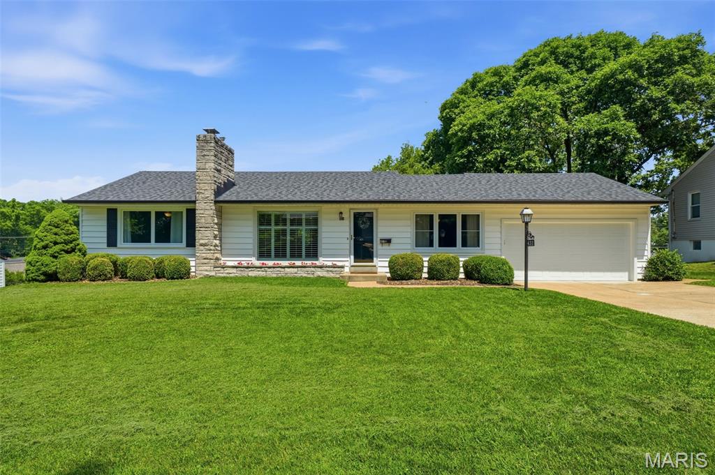 Totally renovated from top to bottom in 2019, this beautifully maintained ranch offers 2,764 square feet of finished living space, a 2-car garage, and chic, elegant curb appeal in one of Webster Groves’ most sought-after neighborhoods. Cherished and lovingly cared for by its current owners, this move-in ready home is ready to welcome its next chapter.

Inside, gorgeous wood floors, elegant archways, and three fireplaces add warmth and character throughout. Oversized windows lining both sides of the home — from the striking picture window in the living room to the kitchen and breakfast nook windows — bathe the main living spaces in natural light. The stunning updated kitchen features white quartz countertops, subway tile backsplash, stainless steel appliances, pantry storage, breakfast bar seating, and a convenient wet bar tucked into the breakfast nook, creating the perfect setup for entertaining while maintaining an intentional and comfortable flow between spaces.

The main level includes 3 bedrooms and a beautifully updated bath with double sinks and designer finishes. The large hearth/ great room addition features a second fireplace and sliding doors leading to the patio and large fenced backyard with plenty of room for entertaining, gardening, pets, or play. The yard gently slopes away from the home, offering organic peace of mind during the wet seasons while enhancing the beauty and usability of the outdoor space.

The partially finished walk-out lower level adds even more living space with a large rec/family room, third fireplace, full bath, and laundry area. Additional updates include an architectural roof, updated HVAC, plumbing, and electrical systems. Beautifully reimagined, thoughtfully designed, and impeccably maintained — this Webster Groves gem truly has it all.