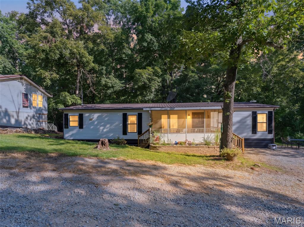 Professional photos coming soon: Welcome to your own private retreat at Lake Timberline! This charming and updated 3 bedroom, 2 bath home is situated on 6 lots totaling approximately 1.6 acres, including a lot located directly on Lake Timberline. Enjoy lake access just seconds from your front door, with a private road leading down to the lake cove—perfect for boating, fishing, swimming, or simply enjoying the peaceful surroundings.

Inside, you'll find a warm and inviting open floor plan with beautiful wood flooring throughout, updated lighting, and plenty of natural character. The spacious living room features a cozy fireplace, creating the perfect gathering space. The updated kitchen offers refreshed cabinetry and flows nicely into the separate dining area, making entertaining family and friends a breeze. All appliances stay with the home, making this property move-in ready.

Outside, relax on the large deck overlooking the wooded backyard and surrounding acreage, or enjoy the added privacy of the screened-in front porch. The property also offers an impressive approximately 1,500 sq. ft. 4-car garage with updated electrical, providing abundant room for vehicles, boats, recreational equipment, a workshop, or additional storage. A roughed-in bathroom in the garage adds even more potential and functionality. The home also features a newer water heater.

With approximately 1.6 acres, lake access, wooded surroundings, an updated home, and the privacy of currently being the only house on the street, this is a rare opportunity to enjoy the space and tranquility of Lake Timberline while still having plenty of room for entertaining and recreation. Come take a look and discover everything this unique property has to offer!
