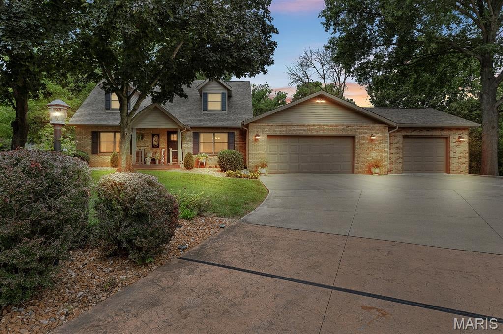 A rare opportunity in Forest Ridge Estates, a well-established and beautifully maintained neighborhood within the sought-after Triad School District. This Inviting traditional 1½-story home with Cape Cod-inspired architecture features an updated kitchen, Stainless appliances, bamboo flooring, formal living and dining rooms, and comfortable family rooms on both the main and lower levels—ideal for everyday relaxation, game nights and holiday gatherings. The lower level also offers a flexible nonconforming bedroom and a storage area with rollout shelving to maximize space and accessibility. Enjoy a spacious main-floor laundry, main-floor bath and three-car garage with a heated and cooled third bay—perfect for hobbies, a workshop or private getaway. The fenced backyard backs to a peaceful treeline, while the screened patio offers a tranquil retreat for morning coffee, quiet evenings and occasional deer sightings.
