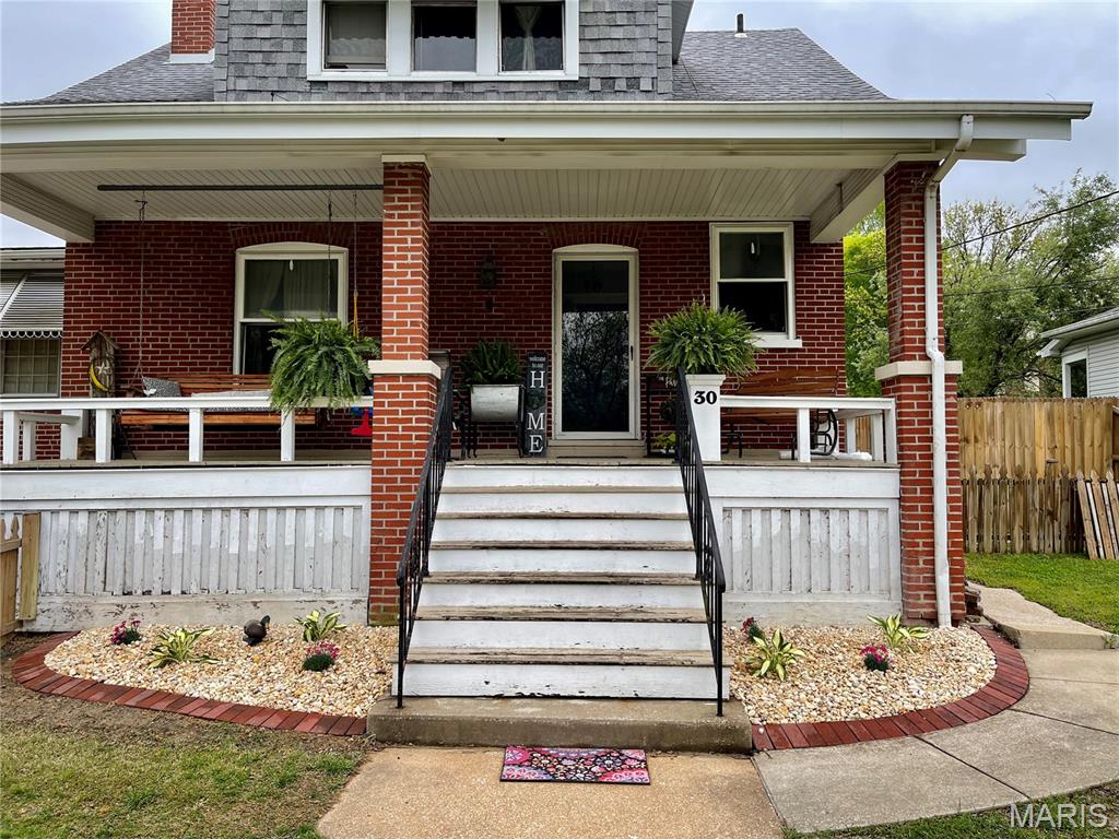 Welcome to the beautiful Historic District of Downtown Belleville. You'll get all the character of the older style home oozing with modern day finishes. Passed City occupancy, move right in! Recent updates include: Stained fencing, Fresh paint, Ceramic flooring and the Basement remodel. If you're looking for hardwood under the flooring in the living room you'll find it! Sip your morning coffee under the expansive covered front porch. Watch the kids play with front and back full fencing. Adorable built-in storage bench in the entryway. Attractive wood burning fireplace with a cute built-in shelf to the left. Large dining room for hosting! Kitchen offers an island, built-ins and the Stainless Steel appliances are all yours! Hardwood floors in the bedrooms with some walk-in closets. Tile flooring in the bathroom. Baseboard radiant heat in the cozy and inviting four-season rooms. Leading to deck access off the back of the house from there. Make a splash in the Salt Water Pool: includes pump equipment and some accessories. Light up your nights with a relaxing illuminated night dip this summer - overhead lights included! Full, finished, walk-out basement with a sizable family room, a BONUS room, bathroom and storage area. Ample parking includes a 1 car attached garage, 6 parking spaces with room in back by the alley access. Only a few minutes from all the buzz and attractions Downtown has to offer year-round! Belleville East School #BluePride #GoLancers